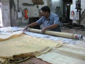 Saris getting ready for a steam which will set the color of the block prints.